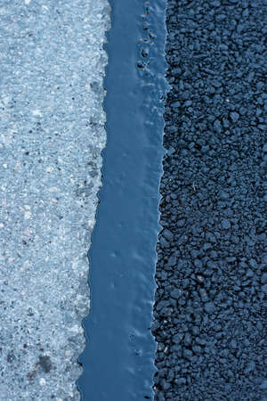 Newly repaired asphalt on a small road