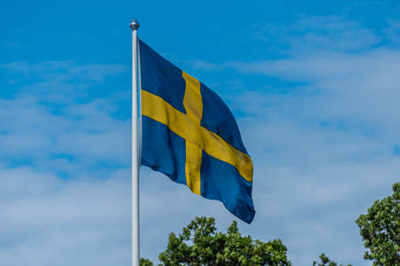 Swedish flag flying from a flag pole