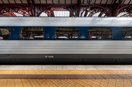 Copenhagen, Denmark - April 13 2009: Passenger train by the platform at a train station.