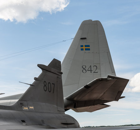 Gothenburg, Sweden - August 29 2010: Tail fins of a SAAB JAS39A Gripen and a Lockheed C-130H-30...