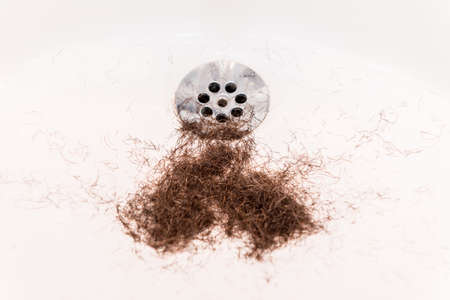 Rests of a beard in the bottom of a sinkの写真素材