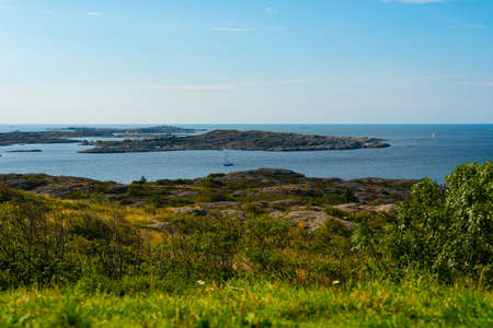 Sunny view over an archipelago. Sail boats crossing in the horizon.の写真素材