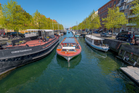 Copenhagen, Denmark - May 12 2017: Sighseeing boat passing through a canal at Christianshavnのeditorial素材