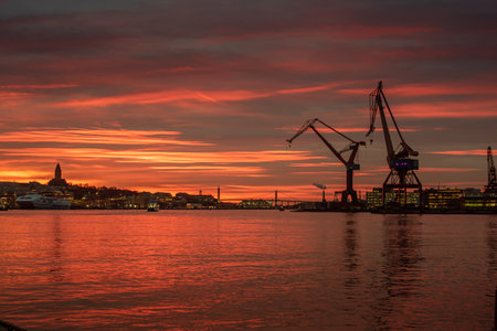 Gothenburg, Sweden - january 11 2019: Beautiful sunset view over cranes at the harbour..のeditorial素材