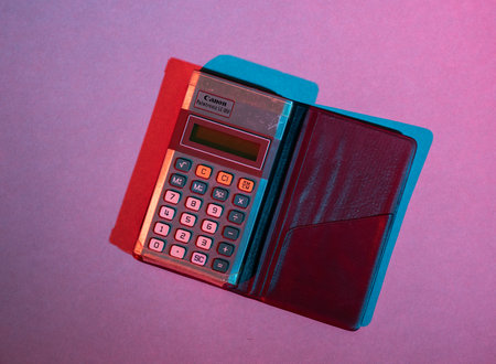 Gothenburg, Sweden - June 17 2019: Canon Palmtronic LC-8M pocket calculator in brue and red light.