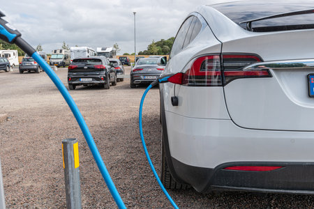MÃ¶lle, Sweden - July 18 2021: Tesla electric car charging in a parking lotのeditorial素材
