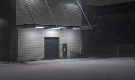 Loading port of a warehouse. Night photo, snowy parking lotの写真素材