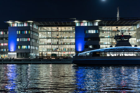 Gothenburg, Sweden - december 17 2021: Nighttime photo of modern offices at Lindholmen, ferry arriving to the pierのeditorial素材