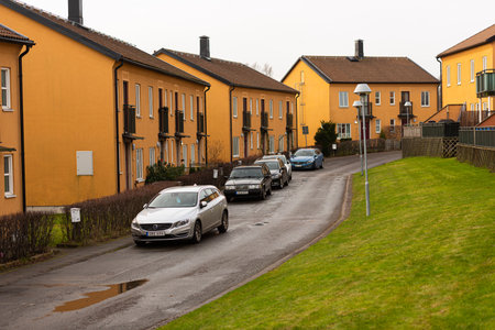 MÃ¶lndal, Sweden - January 13 2022: Five Volvo cars parked by a residential street with orange housesのeditorial素材