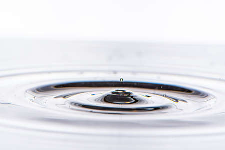 Water drop splashing in clear water.