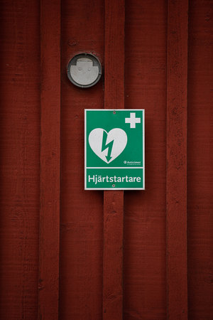 AlingsÃ¥s, Sweden - september 26 2020: Sign on a wall showing that a defirilator is stored inside.