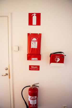 AlingsÃ¥s, Sweden - september 26 2020: A defibrilator, fire blanket and a fire extinguisher on a wall in a house.のeditorial素材