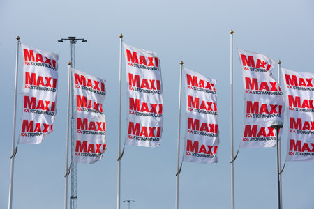 Gothenburg, Sweden - February 20 2022: ICA MAXI flags waving outside a store