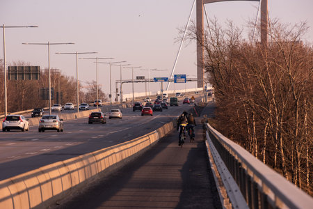 Gothenburg, Sweden - March 23 2022: Bicyclists commuting home from work parallell to the highwayのeditorial素材