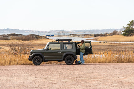 Gothenburg, Sweden - March 27 2022: Couple testing out a Suzuki Jimney at a parking lot by the seaのeditorial素材