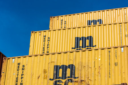 Gothenburg, Sweden - April 03 2022: Yellow MSC shipping containers stacked high