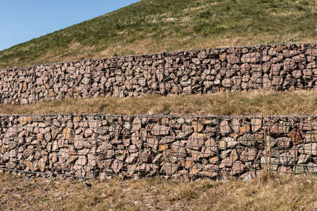 Terraces at a slope built with stones in metal cagesの写真素材