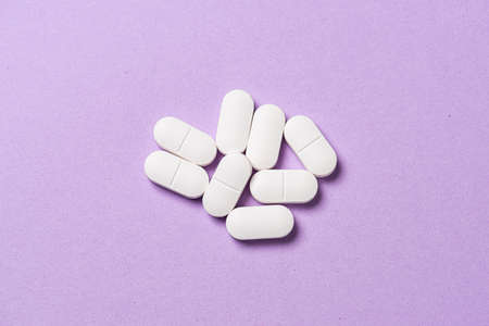 Several white medicine pills on a table