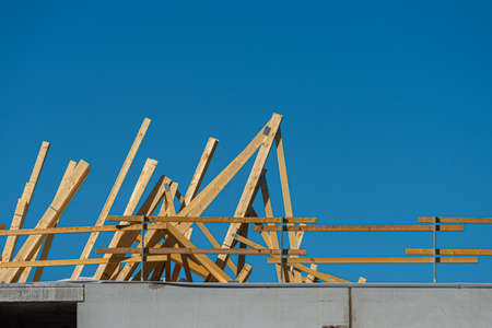 Stacks of planks on the roof of a building at a building site.の写真素材