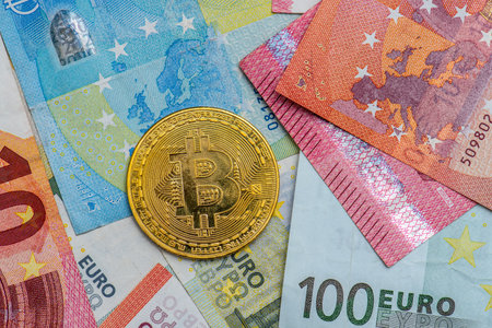 Gothenburg, Sweden - April 30 2022: Shiny golden Bitcoin placed on Euro notesのeditorial素材