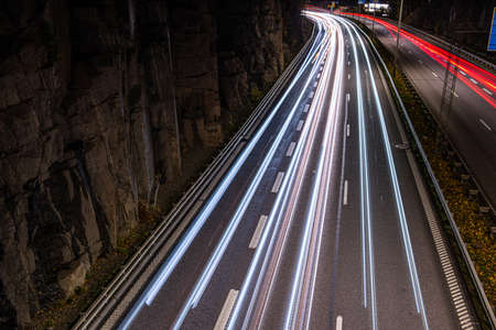 Long exposure night photo of busy highway traffic.