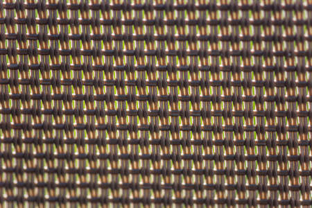 Pattern of woven plastic on a garden chair..