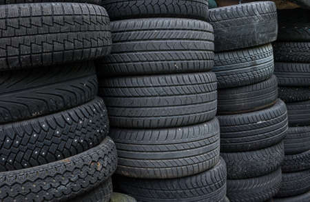 Stacks of used and worn car tyres.