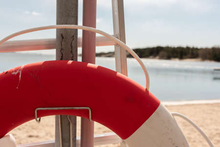 Details of a red and white lifebuoy at a beach.の写真素材
