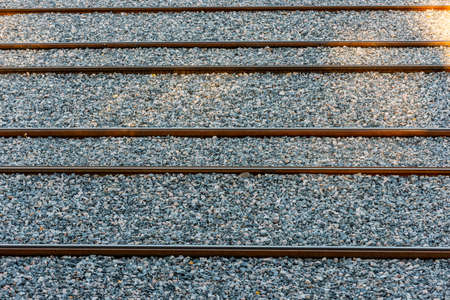 New and straight tram rails on gravel.の写真素材