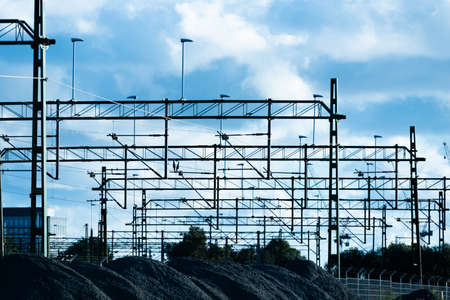 Silhouette of overhead wire power supply at a railway goods depot.の写真素材