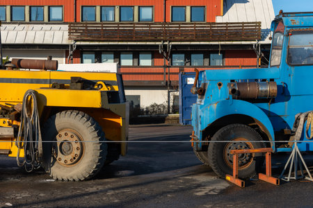 Gothenburg, Sweden - november 21 2021: Old blue and yellow lifting trucks at a wharf.のeditorial素材