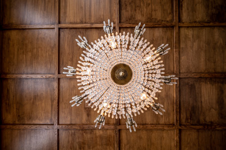 MalmÃ¶, Sweden - July 10 2022: Looking up on a large chandelier with a wooden roof