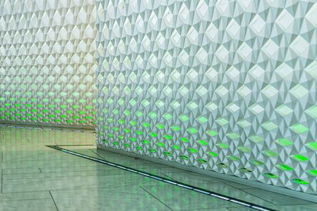 Oslo, Norway - July 19 2014: Abstract texture of a green and white wall. Reflections on the floor..