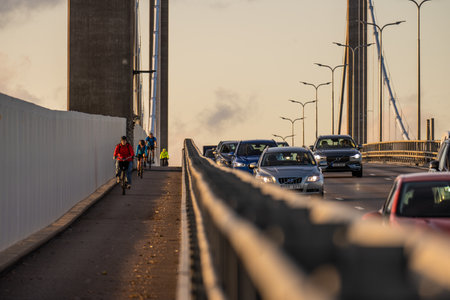 Gothenburg, Sweden - september 14 2022: Bicyclists on bike lane of a suspension bridge along lanes...