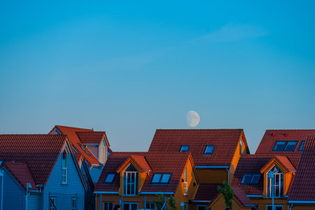Lindesnes, Norway - August 08 2022: The moon rising over a row of summer housesのeditorial素材