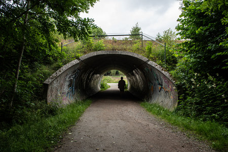 Gothenburg, Sweden - July 11 2021: Person passing through an underpass under a railway lineのeditorial素材