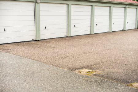 MÃ¶lndal, Sweden - July 31 2022: Six white garage ports at a parking lotのeditorial素材