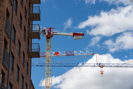 Gothenburg, Sweden - september 04 2022: Tall construction cranes constricting new apartment blocks