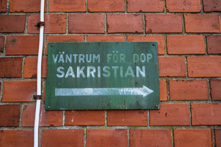 TrollhÃ¤ttan, Sweden - October 08 2022: Green sign showing the direction to the sacristy