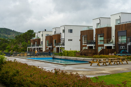 Lindesnes, Norway - August 07 2022: Apartment complex by a small poolのeditorial素材
