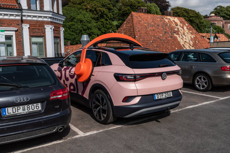 Helsingborg, Sweden - July 17 2021: A pink Volkswagen ID4 electric car with headphones promoting Storytel.のeditorial素材