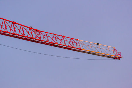 Red and white boom of a construction craneの写真素材
