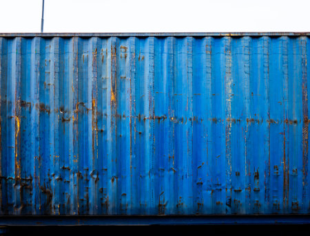 Side of a blue worn shipping containerの写真素材