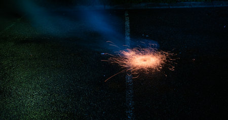 Yellow ground fireworks on asphaltの写真素材