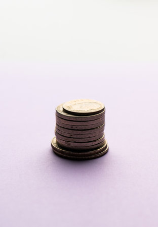 Stack of coins on purple backgroundの写真素材