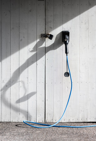 Electrical car charging cable in a carportの写真素材