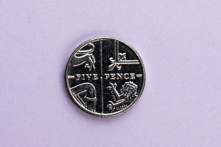 British five pence coin on purple background