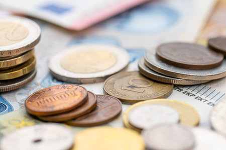 Assortment of coins on bank notes from different countriesの写真素材