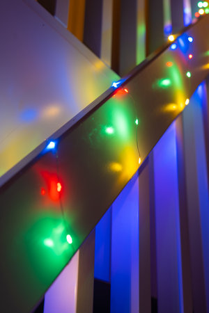 Colorful christmas lights hanging from a railing on stairsの写真素材