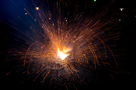 Yellow ground fireworks on asphalt